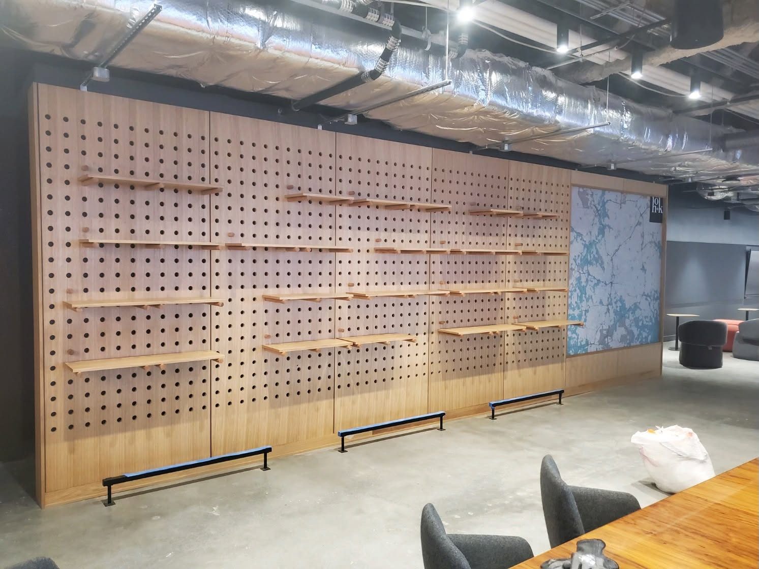 Oak peg feature wall in a workplace office