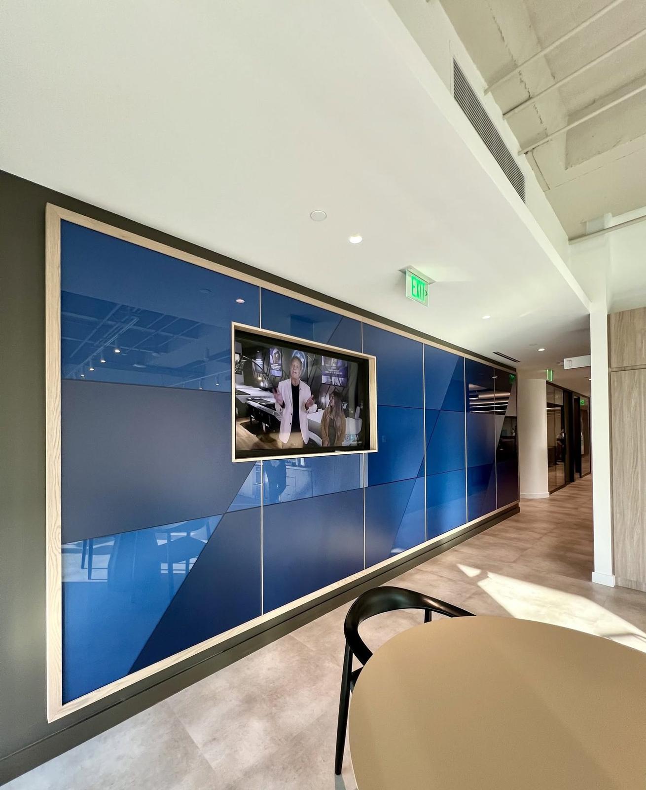 Blue geometric plexiglass wall with an inset display