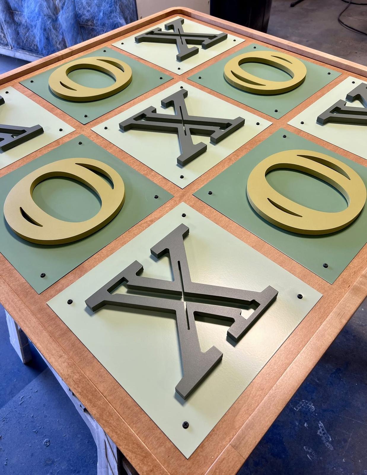 Interactive tic tac toe board with copper X and O forms