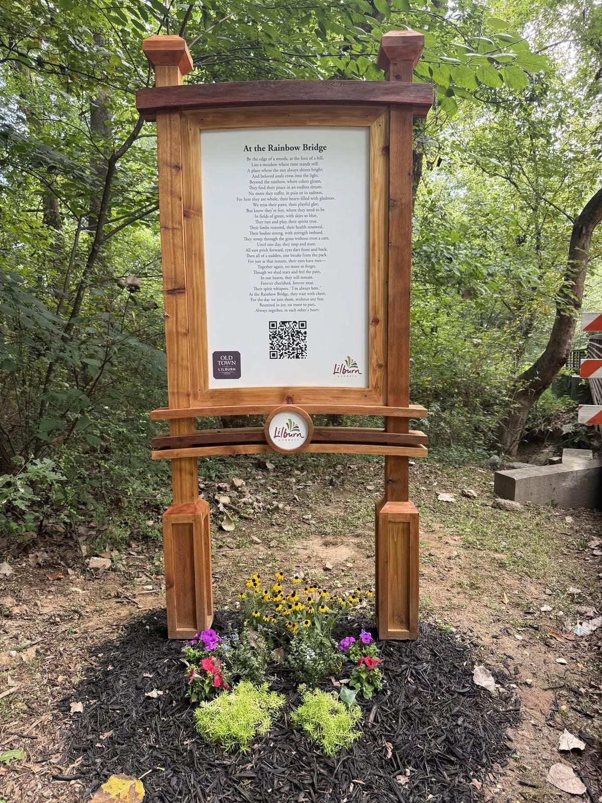 Custom timber trail sign with inset panel and planting